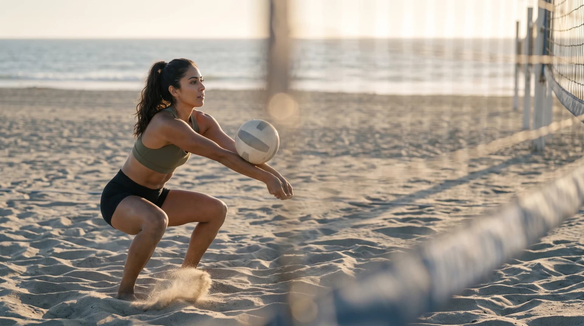 Maya practicing serve receive on a beach volleyball court